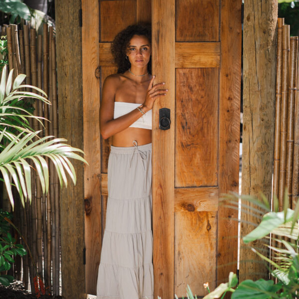 Model standing in doorway of Balinese gate at Tropic Shots production set